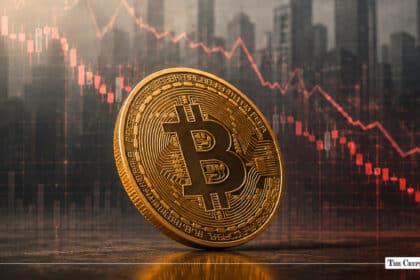 Gold Bitcoin coin in front of a declining red stock chart line over a blurred city skyline backdrop
