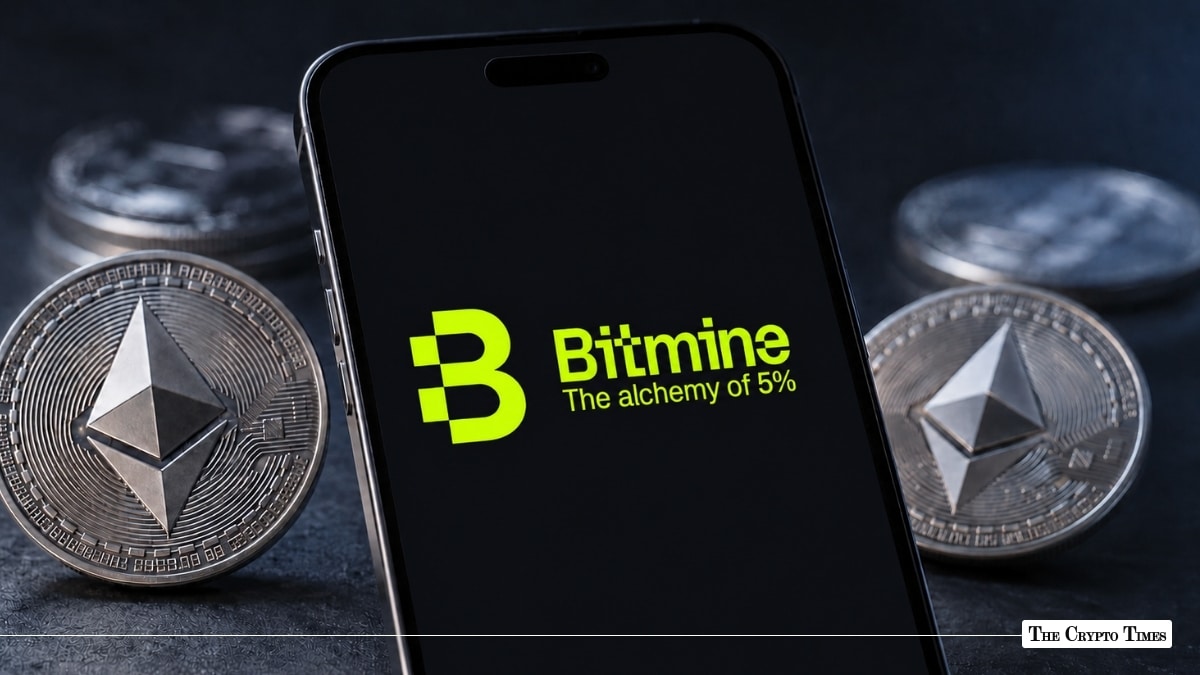 Black smartphone screen displaying the green Bitmine logo and slogan "The alchemy of 5%" surrounded by physical Ethereum coins