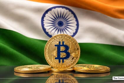 Bitcoin coin standing in front of the Indian flag