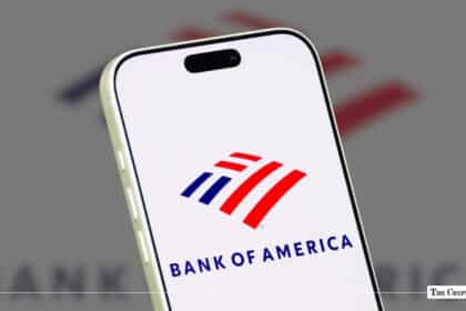 A smartphone displaying the Bank of America logo against a blurred corporate backdrop