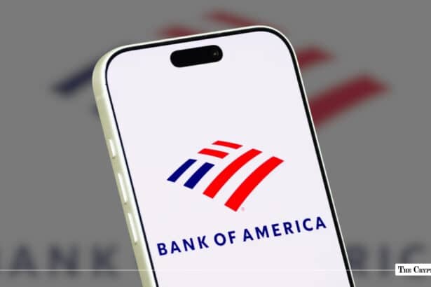A smartphone displaying the Bank of America logo against a blurred corporate backdrop