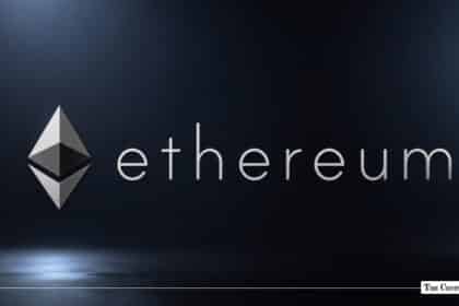 Silver Ethereum logo and lowercase text lit by a soft spotlight on a dark metallic surface