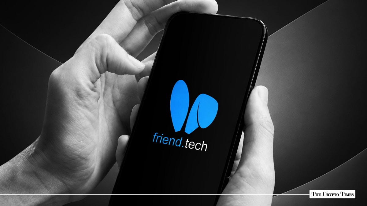 Hands holding a smartphone displaying the blue Friend.tech logo on a black screen