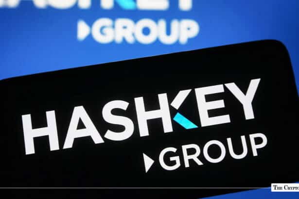 Smartphone displaying the HashKey Group logo against a blurred HashKey background