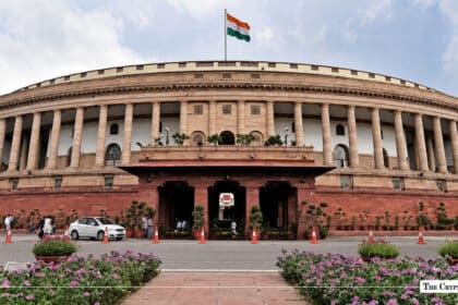 Indian Parliament building with the national flag flying above.