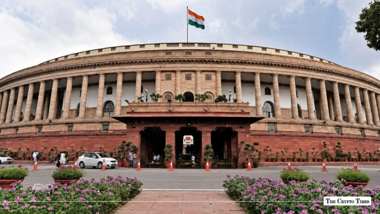 Indian Parliament building with the national flag flying above.