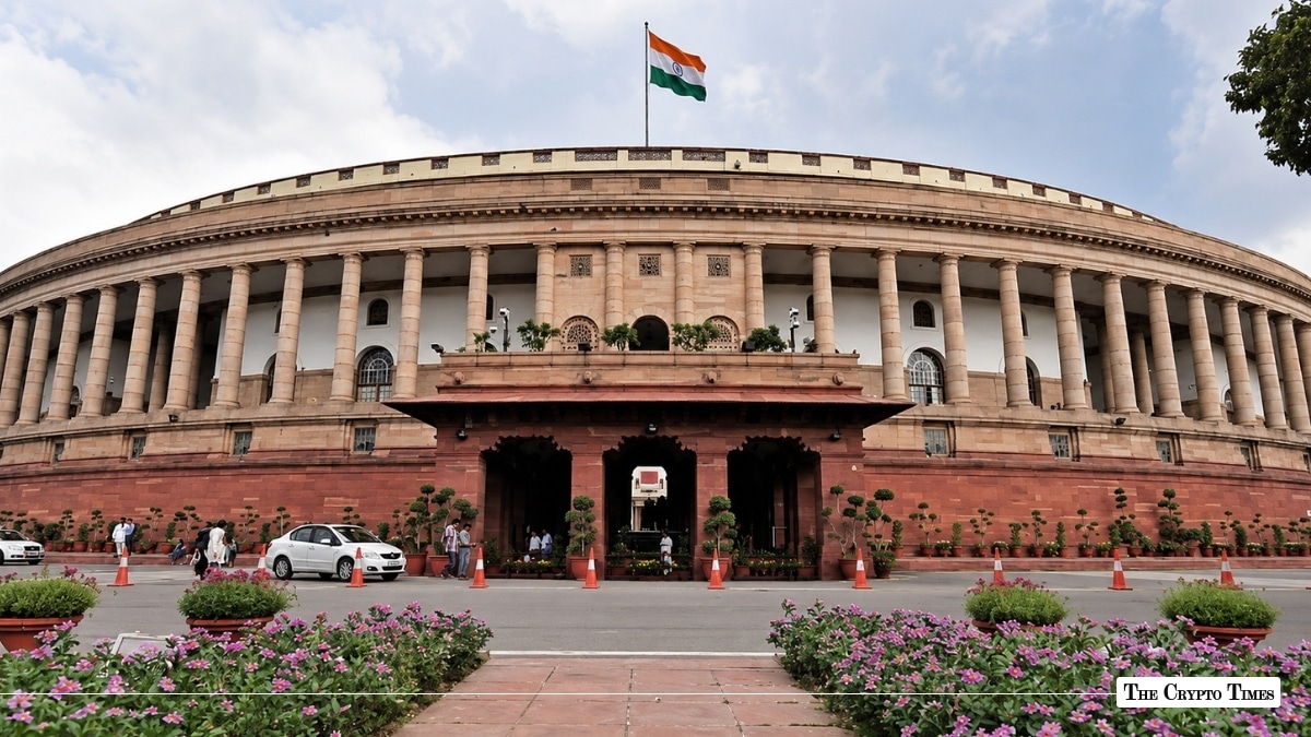 Indian Parliament building with the national flag flying above.
