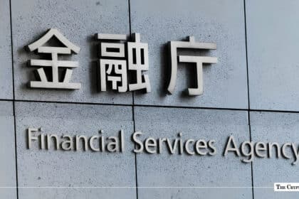 Sign with Japanese characters and English text reading Financial Services Agency on a stone wall