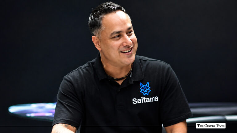 Saitama CEO wearing a black Saitama-branded polo shirt, smiling.