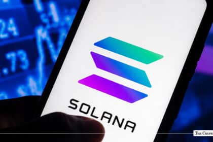 Smartphone screen showing the Solana logo against a blurred financial stock ticker background