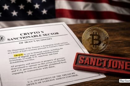 Official document regarding sanctions on Iran next to a gold Bitcoin coin and a red stamp reading "SANCTIONED," with an American flag in the background