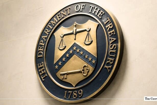 Bronze seal of The Department of the Treasury mounted on a light grey stone wall