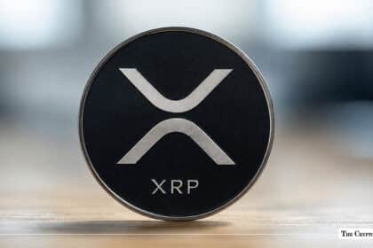 XRP coin with the XRP logo on a dark background.