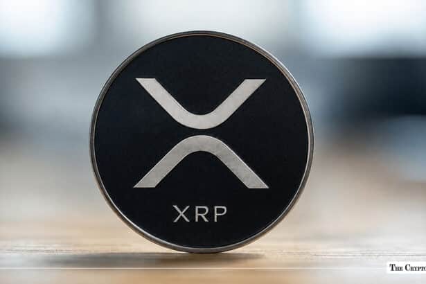XRP coin with the XRP logo on a dark background.
