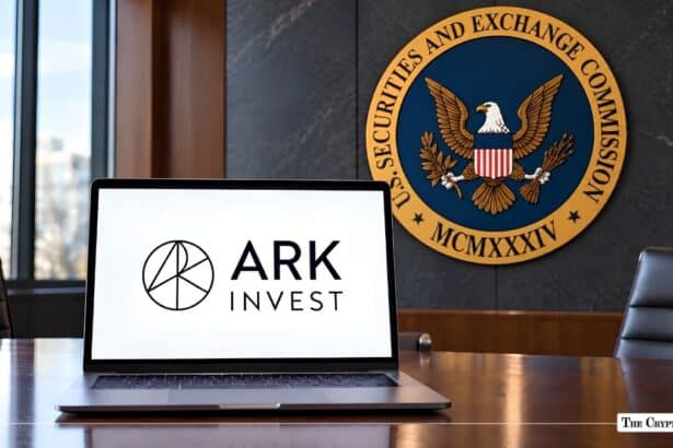 Laptop showing the ARK Invest logo placed on a desk in front of an SEC wall seal.