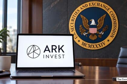 Laptop showing the ARK Invest logo placed on a desk in front of an SEC wall seal.