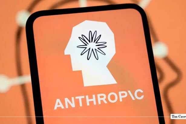 Smartphone displaying the Anthropic logo, a white profile silhouette with a starburst mark, on an orange screen