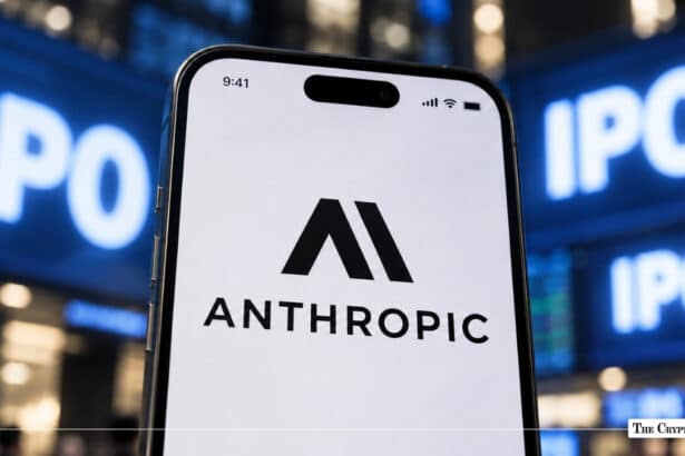 A smartphone displaying the Anthropic logo against a blurred background with illuminated "IPO" signs.