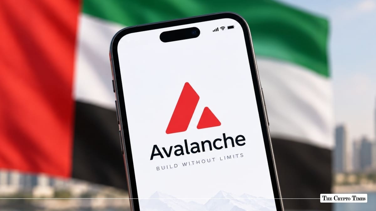A smartphone displaying the Avalanche logo held in front of a blurred UAE flag