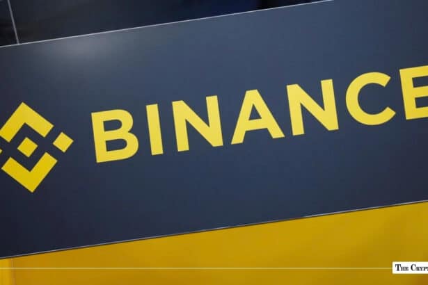 The yellow and black Binance logo displayed on a sign.
