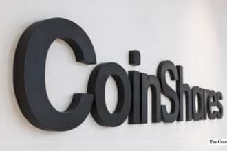 CoinShares logo displayed in black on a white wall.