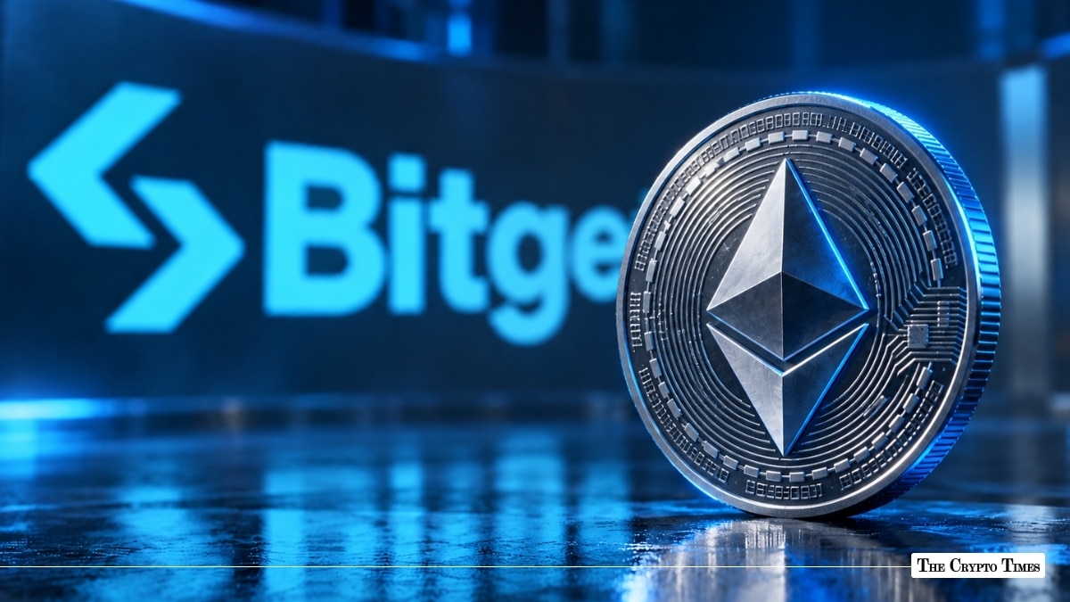 A physical silver Ethereum coin standing upright in front of a blue illuminated Bitget logo on a reflective dark surface.