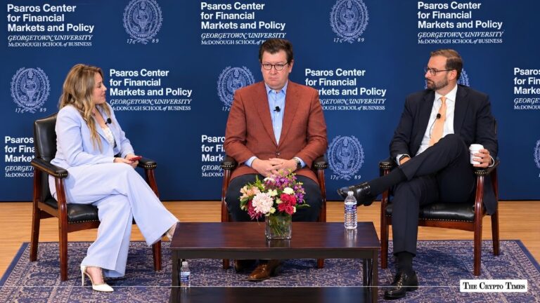 Three speakers seated on a panel stage at the Psaros Center for Financial Markets and Policy.