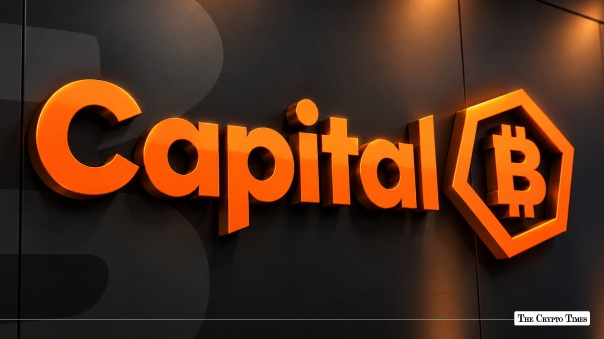 An illuminated 3D Capital B logo with a Bitcoin emblem mounted on a dark wall.