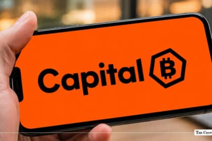 Smartphone displaying the Capital B logo with a Bitcoin emblem on a bright orange background