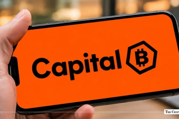 Smartphone displaying the Capital B logo with a Bitcoin emblem on a bright orange background