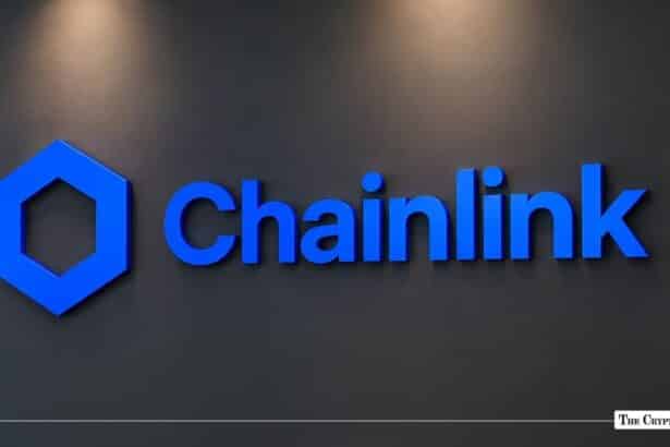 Blue 3D Chainlink logo and text signage mounted on a dark matte wall.