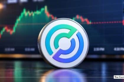 Physical USD Coin (USDC) token standing upright against a financial trading chart background.