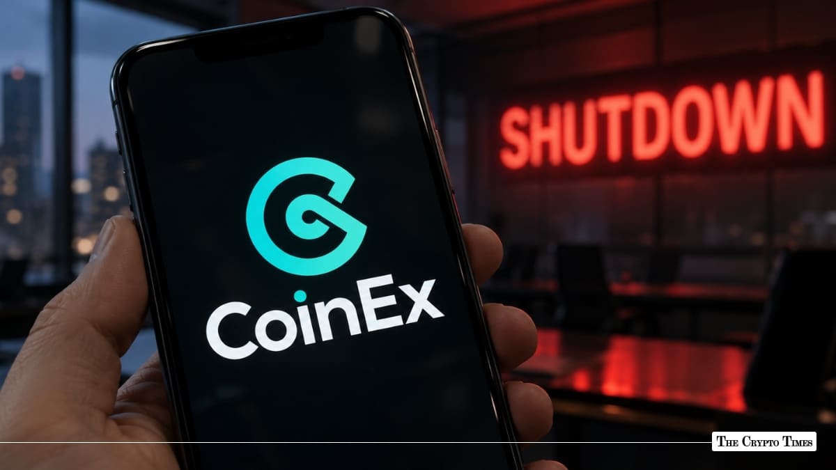 Hand holding smartphone displaying CoinEx crypto exchange app logo with glowing red SHUTDOWN sign in background