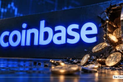 An illuminated blue Coinbase logo on a dark wall beside a breached metallic vault spilling gold Bitcoin coins onto the floor.