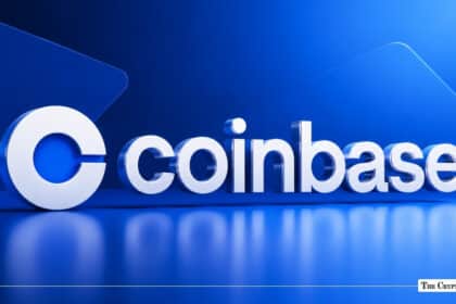 3D white Coinbase logo resting on a glossy blue reflective surface