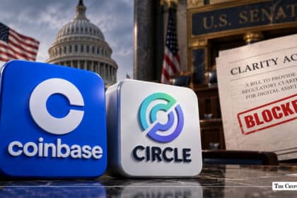 Coinbase and Circle logos next to a CLARITY Act document stamped "BLOCKED" in front of the U.S. Capitol
