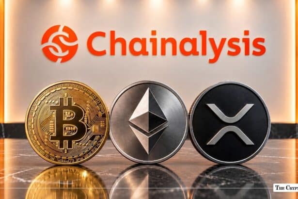 Physical Bitcoin, Ethereum, and XRP coins resting in front of an illuminated Chainanalysis wall sign.