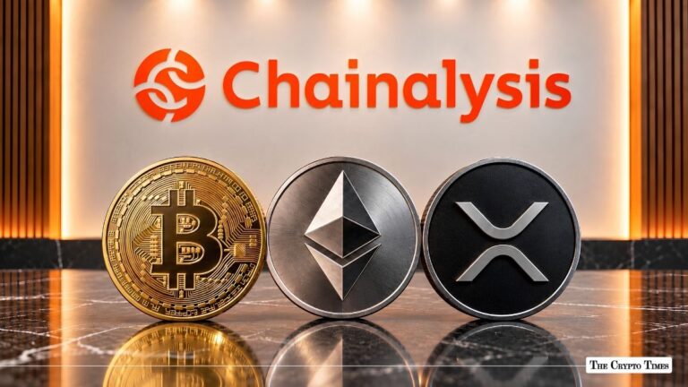 Physical Bitcoin, Ethereum, and XRP coins resting in front of an illuminated Chainanalysis wall sign.