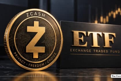 Gold Zcash (ZEC) physical coin standing alongside a sleek black card with gold embossed text reading "ETF EXCHANGE TRADED FUND" against a blurred financial chart