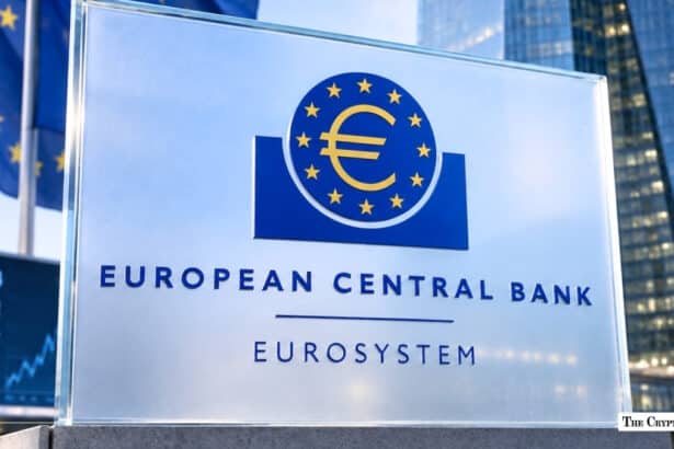 A transparent sign displaying the European Central Bank Eurosystem logo positioned in front of a financial ticker board and modern office building.