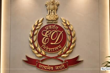 Enforcement Directorate emblem in gold and maroon mounted on a wall, with the Ashoka Lion Capital above it