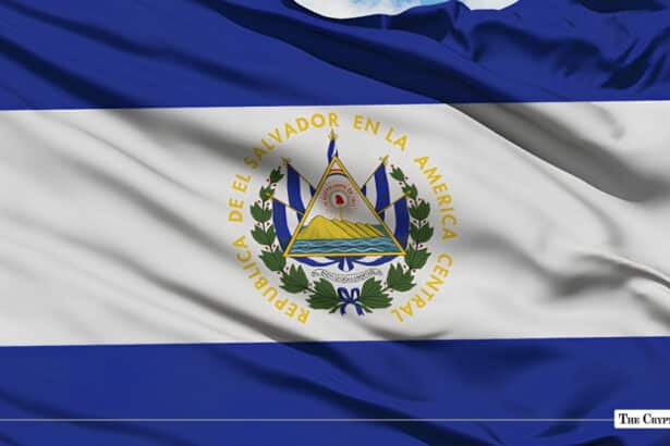 The national flag of El Salvador fluttering against a clear blue sky.