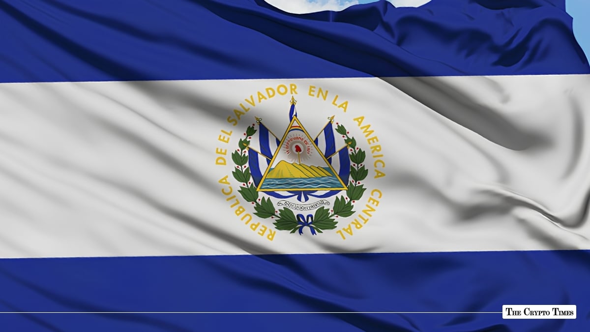 The national flag of El Salvador fluttering against a clear blue sky.