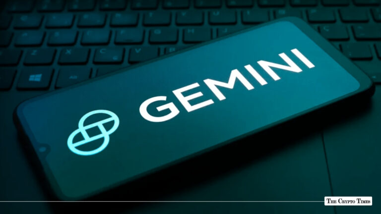 Gemini crypto exchange logo displayed on smartphone screen over laptop keyboard