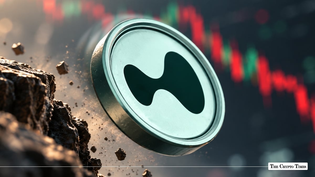 Silver crypto token coin featuring a dark abstract fluid logo crashing down near a declining red market chart