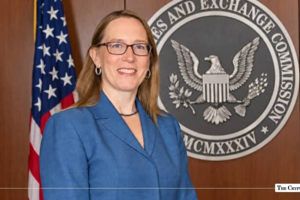 SEC Commissioner Hester Peirce standing in front of the U.S. Securities and Exchange Commission seal and the American flag.
