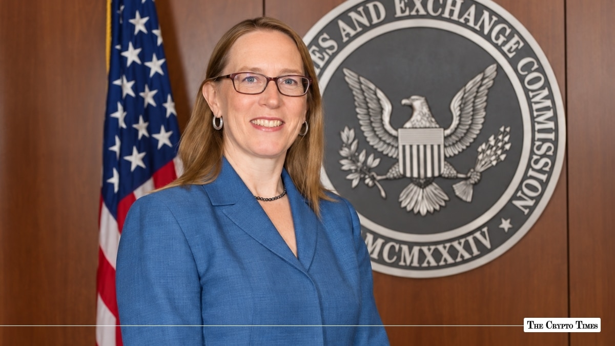 SEC Commissioner Hester Peirce standing in front of the U.S. Securities and Exchange Commission seal and the American flag.