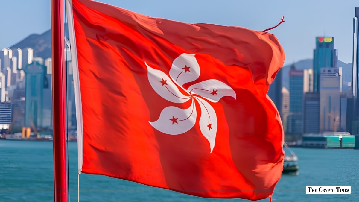The flag of Hong Kong fluttering against the backdrop of the Victoria Harbour skyline.