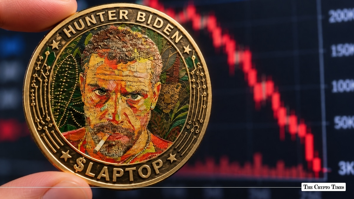Fingers holding a gold $LAPTOP coin stamped with Hunter Biden's likeness against a steep red declining candlestick chart dropping from 200K to 3K