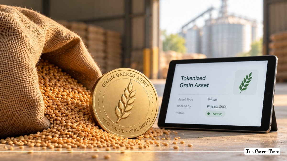 Gold "Grain Backed Asset" coin stamped with a wheat sheaf sitting in loose grain beside a spilled burlap sack, positioned next to a tablet displaying "Tokenized Grain Asset" on an active dashboard